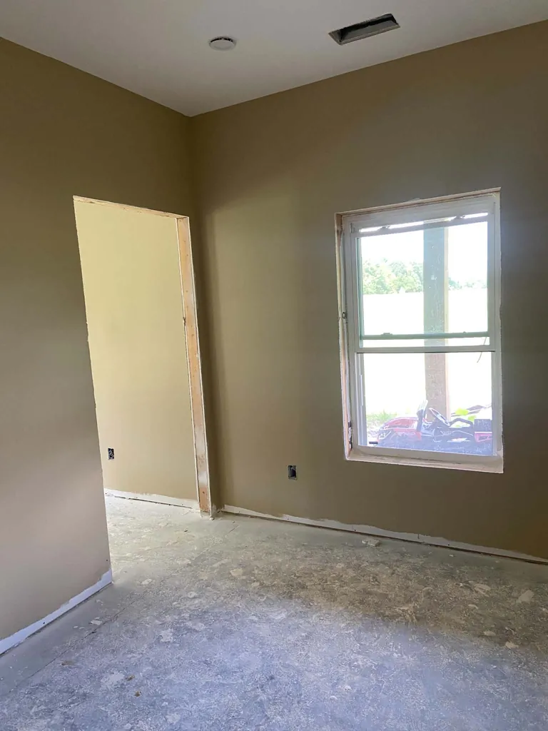 Bedroom with finished sheetrock walls, painted ceiling, and window return
